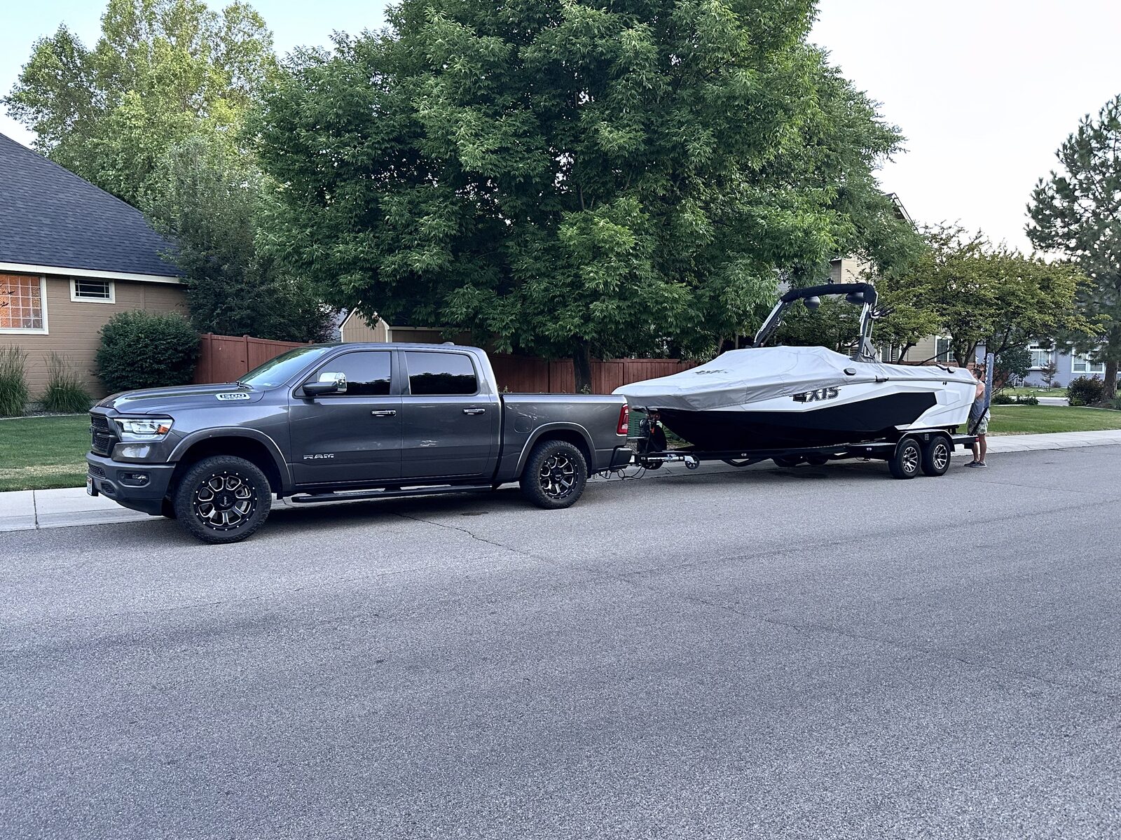 The Elroy Rentals Axis wakeboard and surf boat loaded on its trailer behind a truck