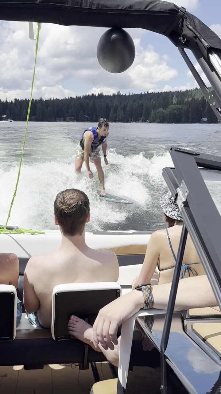 Surfer carving the boat's wake